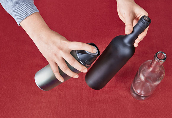 Un centro de Navidad con botellas y ponsettias